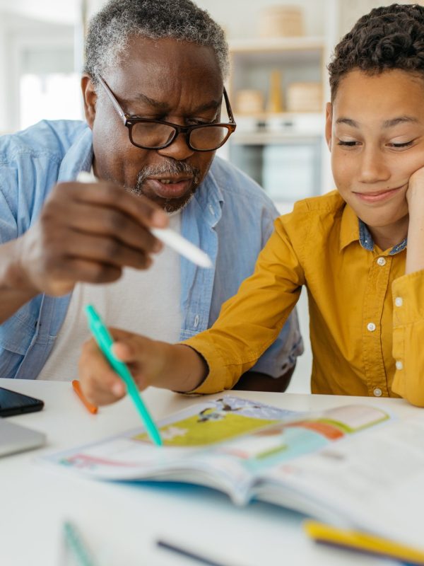Grandfather,Tutoring,His,Grandson,At,Home.,The,Child,Is,Patiently
